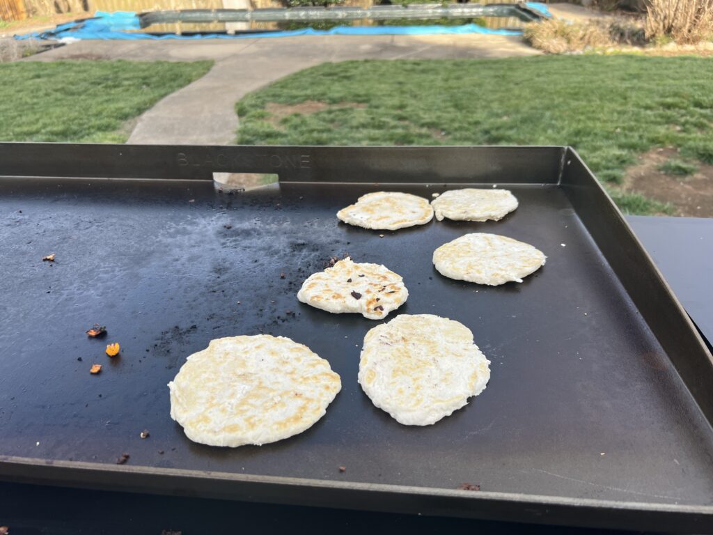Homemade flour tortillas cooking on the griddle