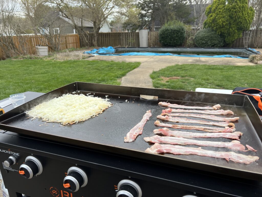 Hash browns and bacon just added to the griddle for the first breakfast attempt