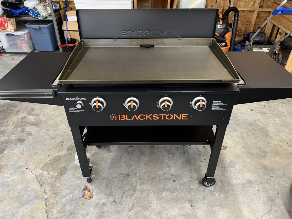 Brand-new 4-burner Blackstone griddle, freshly assembled in the garage
